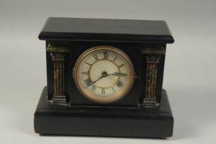 A VICTORIAN MAHOGANY MANTLE CLOCK with circular dial and column sides. 13ins long, 10ins high.