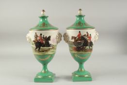 A PAIR OF SEVRES DESIGN PORCELAIN URN SHAPED VASES AND COVERS decorated with hunting scenes. 12ins