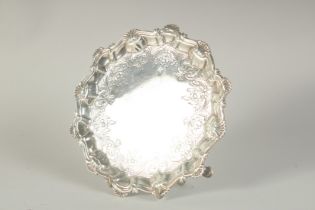 A GOOD GEORGE III SILVER PIE CRUST SALVER with shell borders on three pad feet. 7ins diameter.