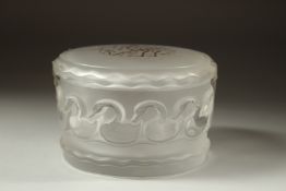 A LALIQUE FROSTED GLASS CIRCULAR POWDER BOWL AND COVER the lid with gilt caligraphy. Signed, Lalique