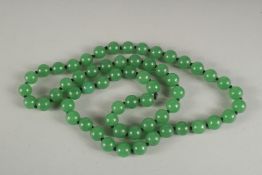 A STRING OF JADE BEADS. 24ins long.
