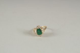 A GOOD YELLOW GOLD EMERALD AND DIAMOND RING.