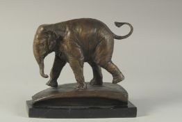 A BRONZE ELEPHANT on a marble base. 8ins high.