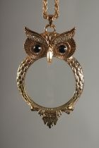 BRONZO. A GILT OWL MAGNIFYING GLASS on a chain.