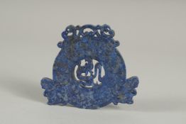 A LAPIS CARVED AND PIERCED ROUNDEL.