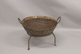 A GOOD CAST IRON FIRE PIT with carrying handles, on four curving legs. 2ft diameter.