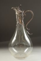 A PLAIN GLASS CLARET JUG with silver mounts and handle. London 1933.