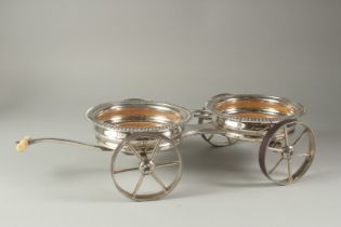 A GOOD REGENCY SILVER PLATED DOUBLE TABLE COASTER on four wheels with bone handle.