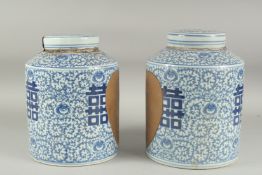 A PAIR OF CHINESE BLUE AND WHITE GINGER JAR AND COVER. 11ins high.