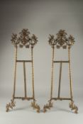 A LARGE PAIR OF BRASS EASLES. 2ft 8ins long.