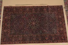 A GOOD PERSIAN PART SILK RUG blue and red ground with stylised floral design. 7ft 7ins x 4ft 10ins.