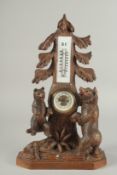 A GOOD CARVED BLACK FOREST CLOCK AND THERMOMETER carved with two bears. 5ins high.