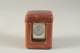A MINIATURE BRASS CARRIAGE CLOCK, with white enamel dial and leather travelling case. 3ins high