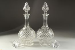 A GOOD PAIR OF SLICE CUT SHERRY DECANTERS AND STOPPERS and another pair of stoppers.