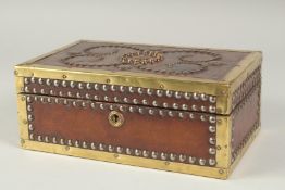 A STUDDED LEATHER BRASS BOUND CASKET. 10ins long, 6ins wide, 4ins high