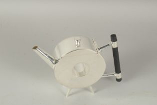 A CHRISTOPHER DRESSER STYLE SILVER PLATED CIRCULAR TEA POT with a hole.