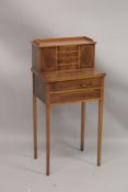 A SMALL YEW WOOD DESK the top with three drawers and a pair of panel doors, fold over flap over