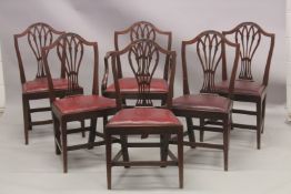A SET OF SIX HEPPLEWHITE DESIGN SHIELD BACK DINING CHAIRS one with arms, with leather drop in
