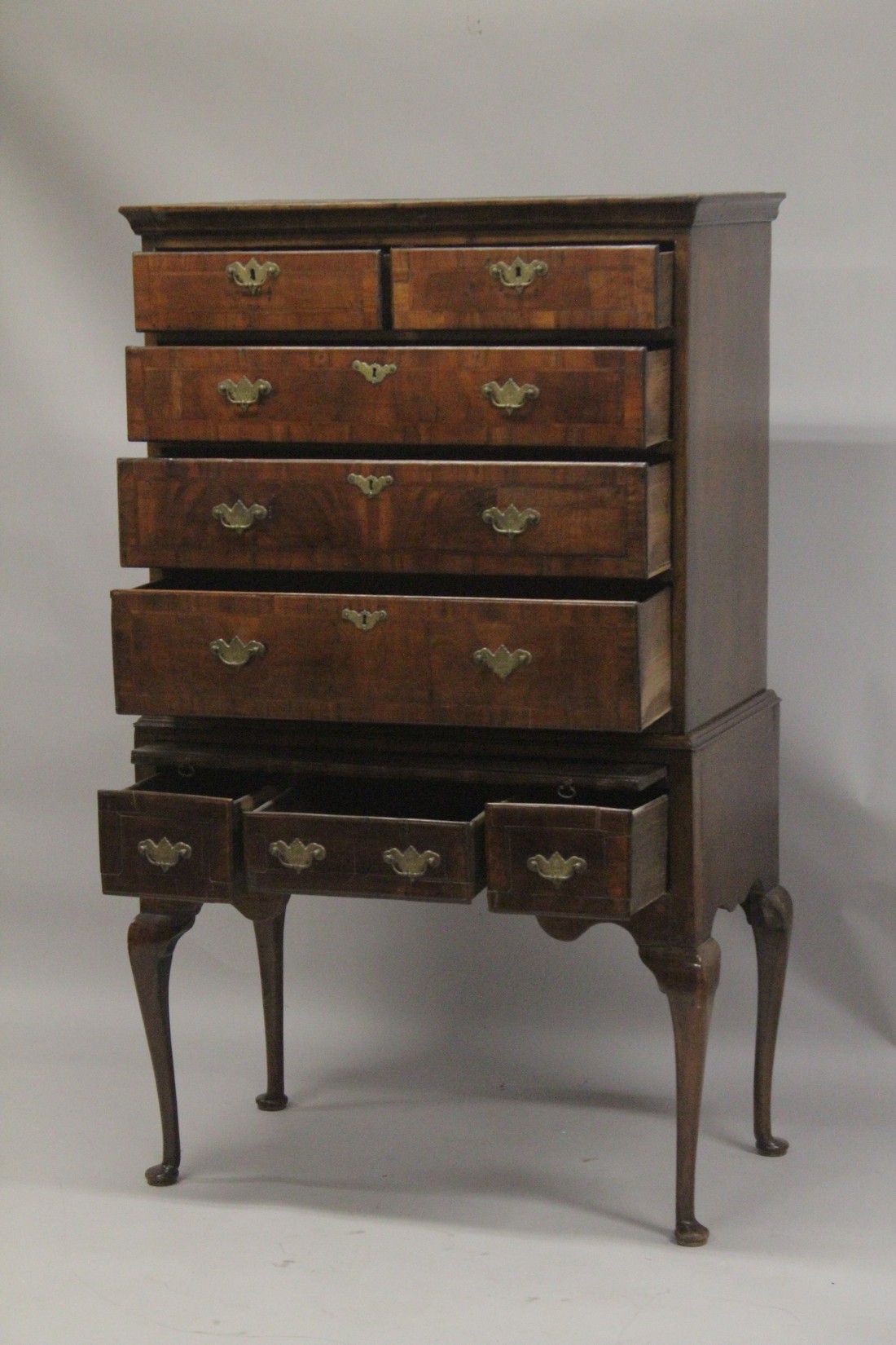 AN 18TH CENTURY OAK AND WALNUT CHEST ON STAND the top with two short and three long graduated - Image 3 of 4