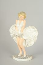 A PAINTED CAST IRON FIGURE OF MARILYN MUNROE. 12ins high.