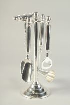 A SILVER PLATED STAND MOUNTED WITH BAR ACCESSORIES. 10.5ins high.