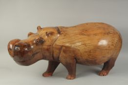 A LARGE HEAVY CARVED WOOD HIPPOPOTAMUS. 3ft long, 1ft 4ins high.