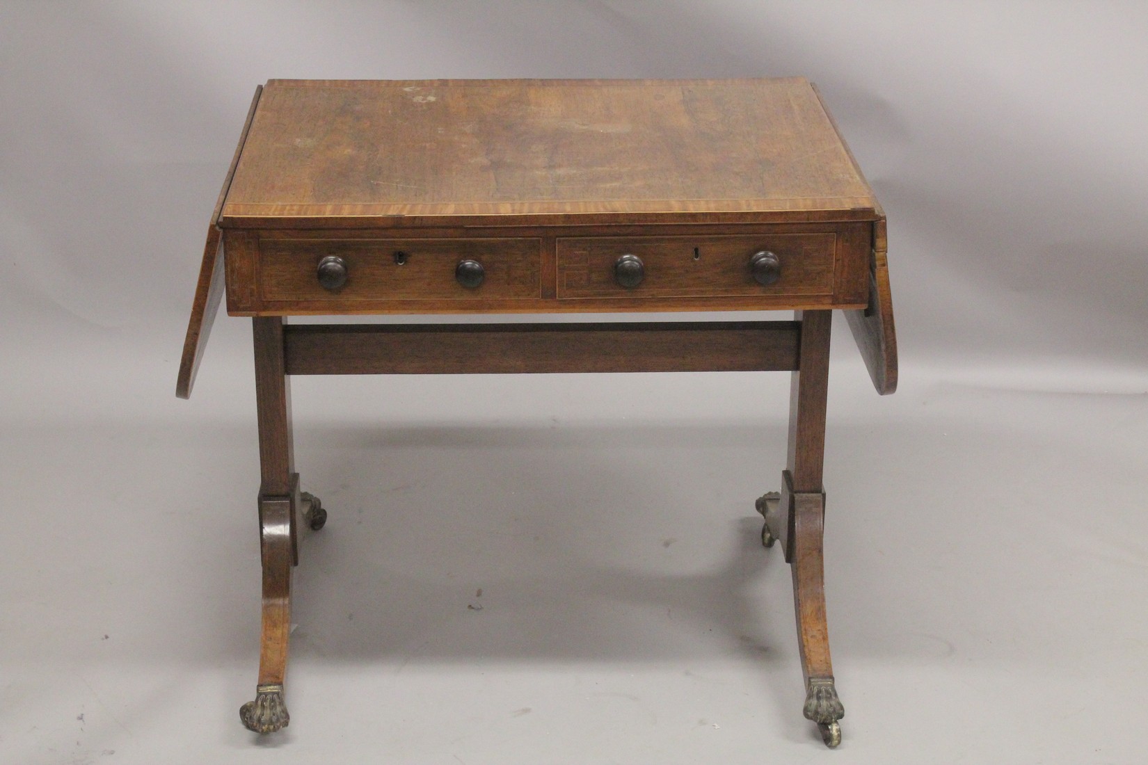 A REGENCY ROSEWOOD SOFA TABLE with folding flaps, on curving legs with casters. 4ft 4ins long