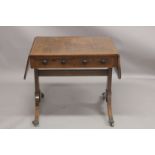 A REGENCY ROSEWOOD SOFA TABLE with folding flaps, on curving legs with casters. 4ft 4ins long