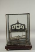 A GOOD CONGREAVE ROLLING BALL CLOCK with three dials in a glass case.