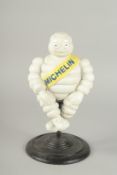 A CAST IRON MICHELLIN MAN on a stand. 11ins high.