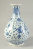 A CHINESE BLUE AND WHITE PORCELAIN VASE painted with phoenix and lotus. 33cm high.