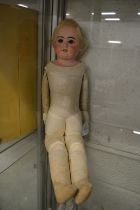 A porcelain headed doll.