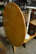 A large modern circular oak dining table.