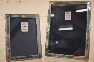 Two silver photograph frames with reeded borders, photo sizes 7" x 5" and 5" x 3½".