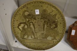 An Eastern engraved brass dish.