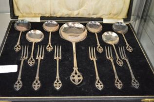 A cased set of plated dessert forks and spoons.