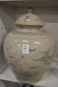 A large Chinese pottery jar and cover.