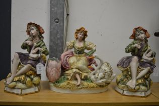 Three decorative figure groups.
