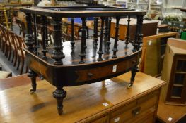 A Victorian ebonised and figured walnut three division bow fronted Canterbury.