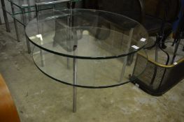 A stylish glass and chrome two-tier circular coffee table.