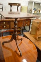 A mahogany tripod table.