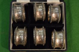 A cased set of six numbered silver napkin rings.