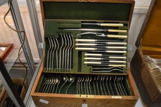 An oak cased plated canteen of cutlery.