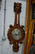 Emilio Zuccani, a good large barometer/thermometer with carved frame, the top fashioned in the