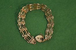 A 9 carat gold bracelet with padlock clasp.
