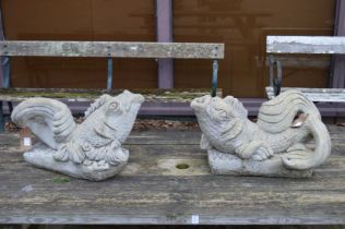A pair of reconstituted stone dolphin water features.