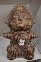 A pre Colombian style painted pottery seated figure.