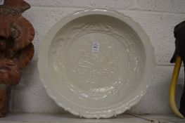 A large Chinese blanc de chine dish with moulded decoration.