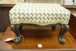A small upholstered stool.
