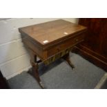 A 19th century rosewood combination table with folding rectangular top, single frieze drawer and